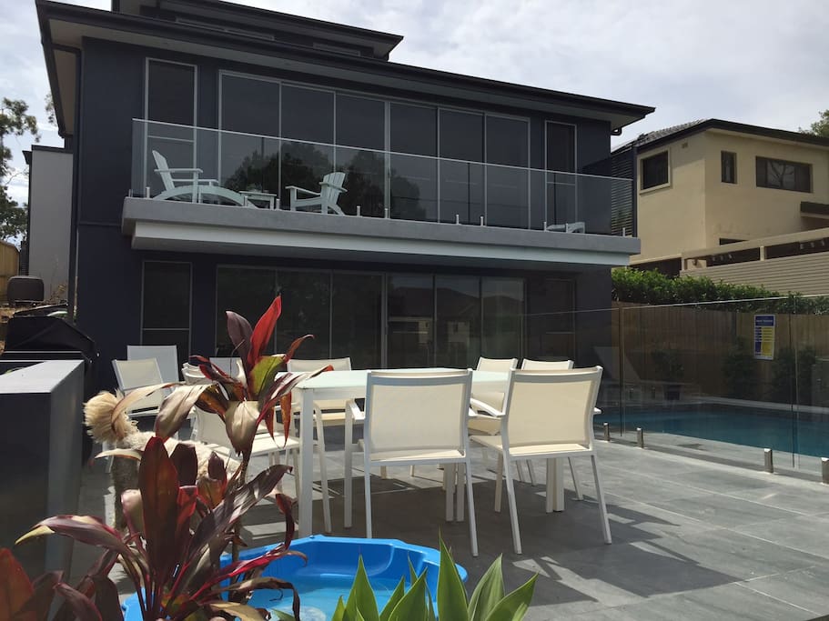 Rear of home showing the 8 seat outdoor table (there are also 2 matching lounges in the background)
