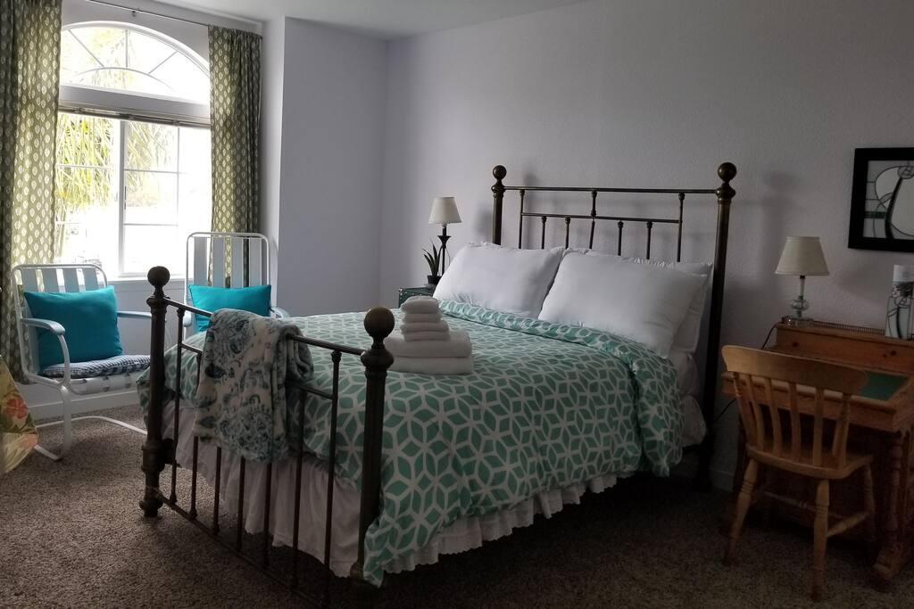 Double bed room TV, Chest of drawers, desk & chair, coffee station, walk-in closet and 2 chairs as well as pleasing foliage view outside the window.