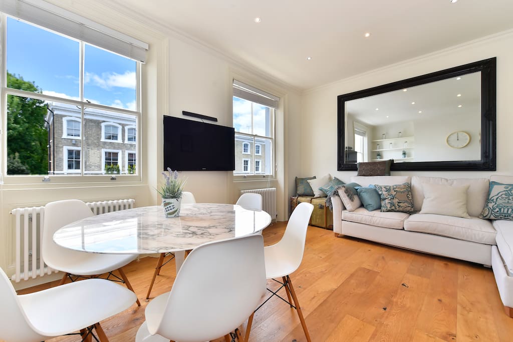 The open plan dinning/living/kitchen area is bright light and spacious with TV and sofa which turns into a double bed.
