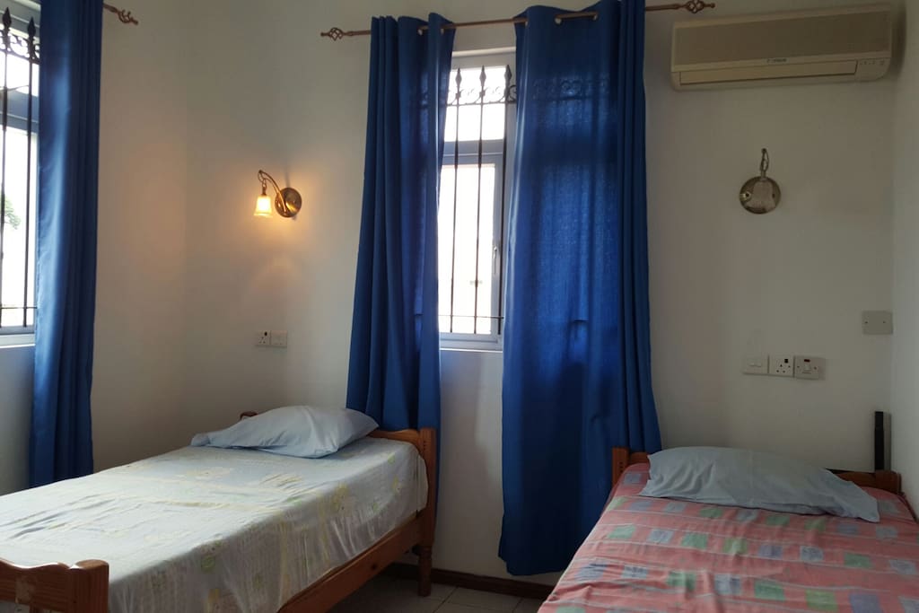 2nd a/c bedroom with 2 single beds with ceiling fan also.