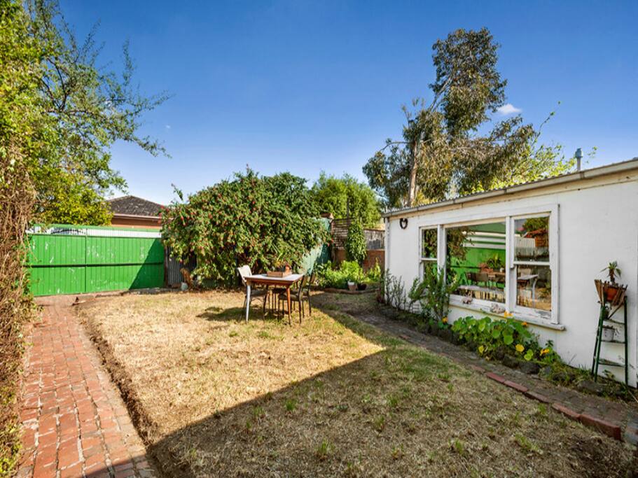The Backyard with a giant shed and veggie patch.