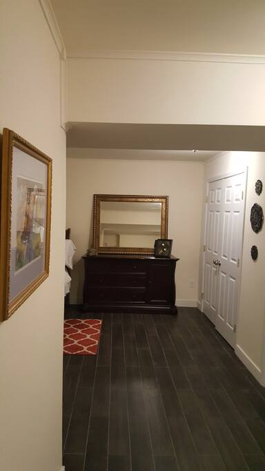 Bedroom with chest of drawers and mirror.