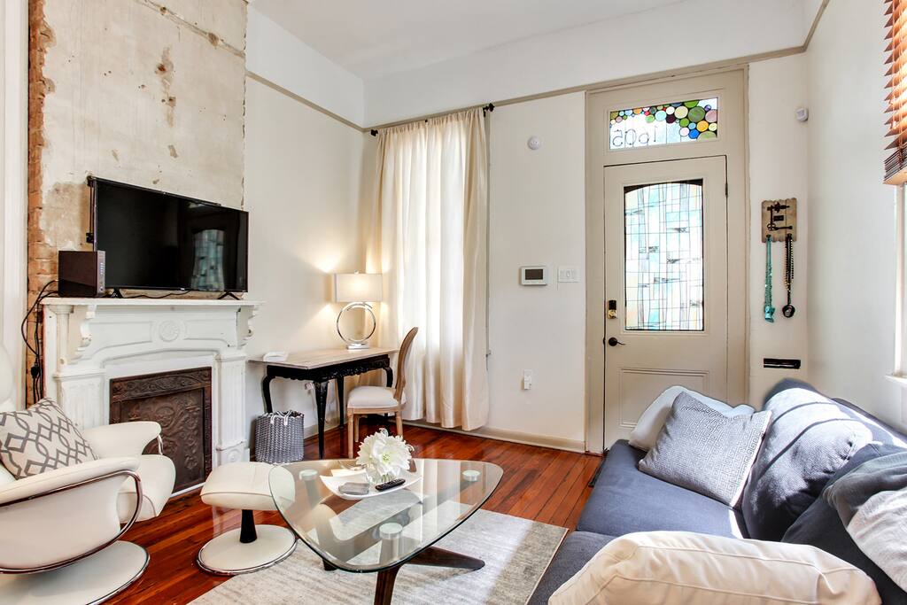 Bright and airy front room with original fireplace. Hardwood floors throughout home.