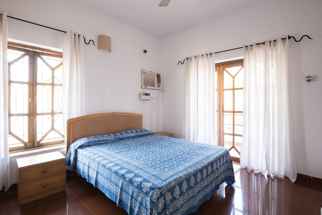 Bed room with a sit out overlooking the valley beyond..