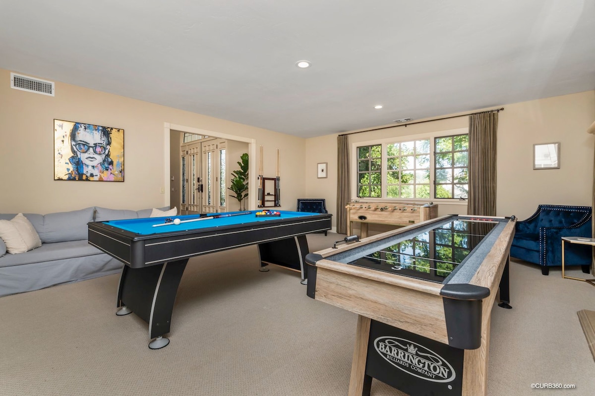 Main Level: Game room with tv, couch, pool table, arcade games, foosball, shuffleboard