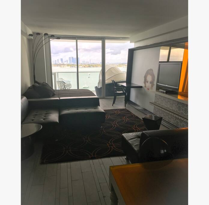 Living room/ 1 st bedroom with balcony bay view and the kitchen