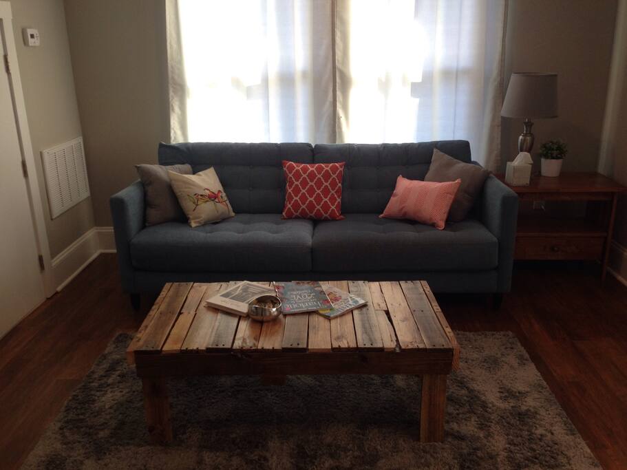 Comfortable couch with custom reclaimed pallet wood coffee table