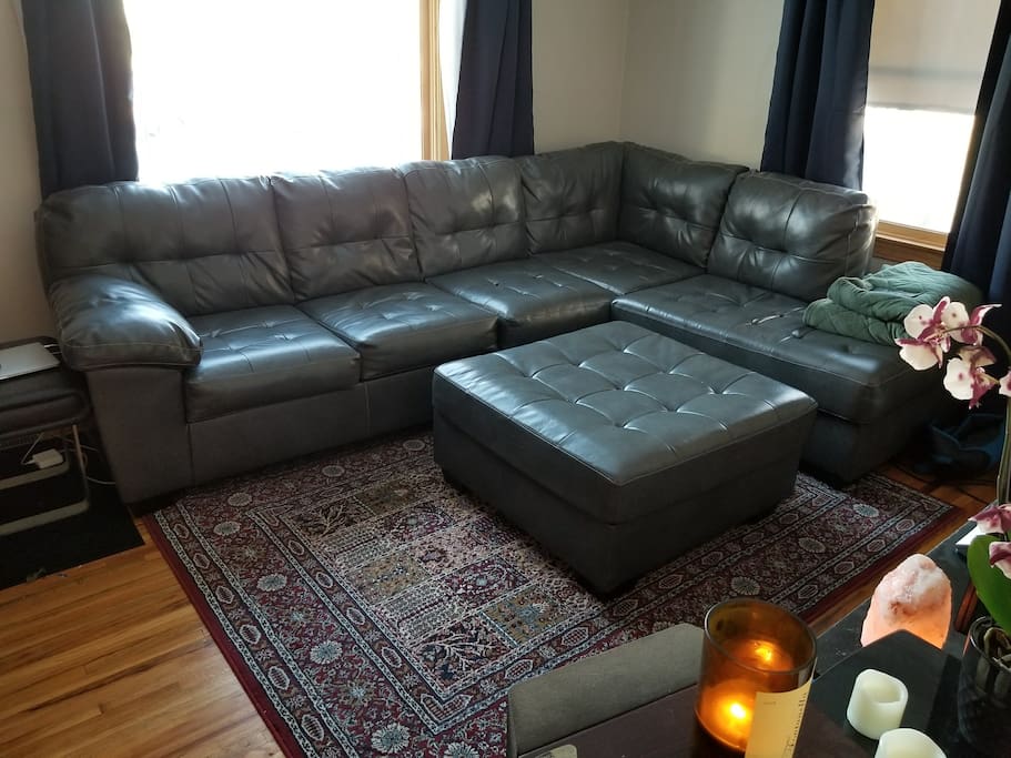 Large living room couch with room for 1-2 people to sleep.