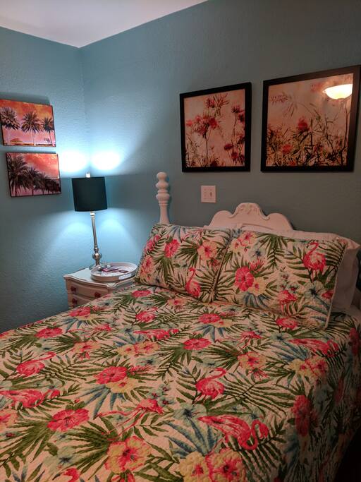 Comfortable, full size bed in beachscape themed room with private bath.