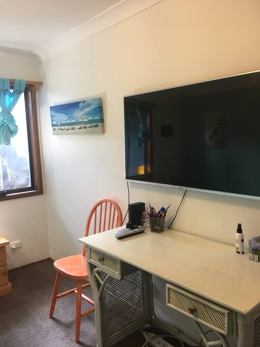 Your own 50" flat screen with desk for any work you may have to do in the privacy of your own room