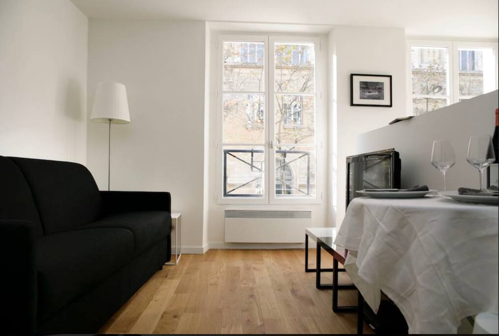 There are now curtains on the windows (not there at the time of the shooting). The table is now a folding table where 2 guests can seat comfortably..