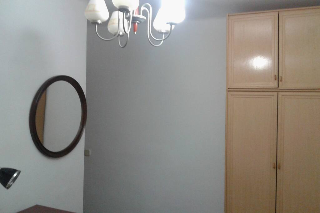 A vintage wall mirror and sizeable wardrobe for your cloths, shoes and luggage