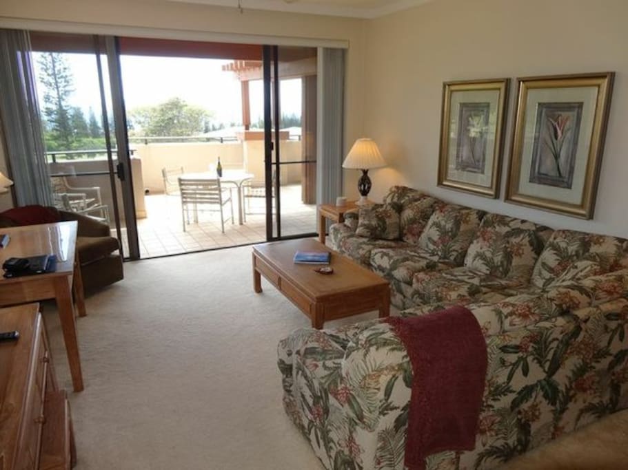 Living room with a view toward the lanai and ocean