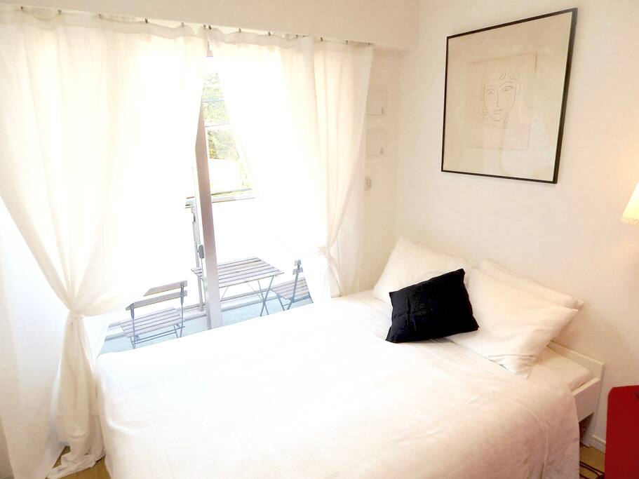 Comfortable natural light streaming in from the balcony with outdoor table & chairs