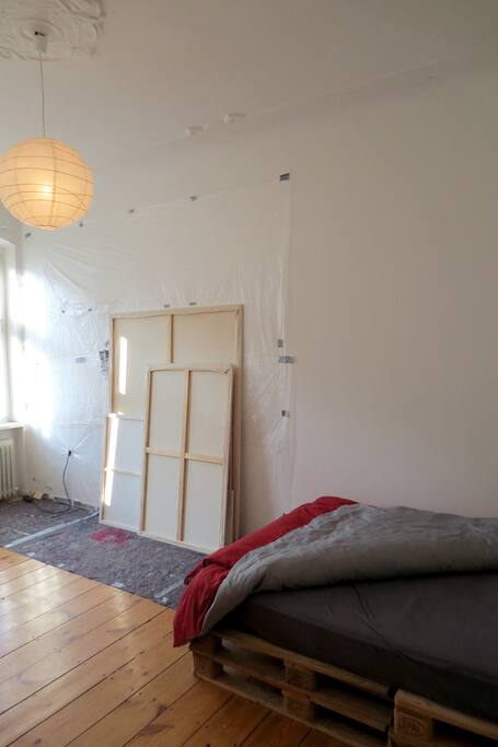 The bed and some paintings.