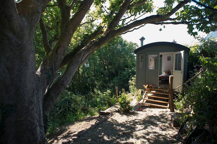 Shepherds Hut in sheltered valley and path to cove
