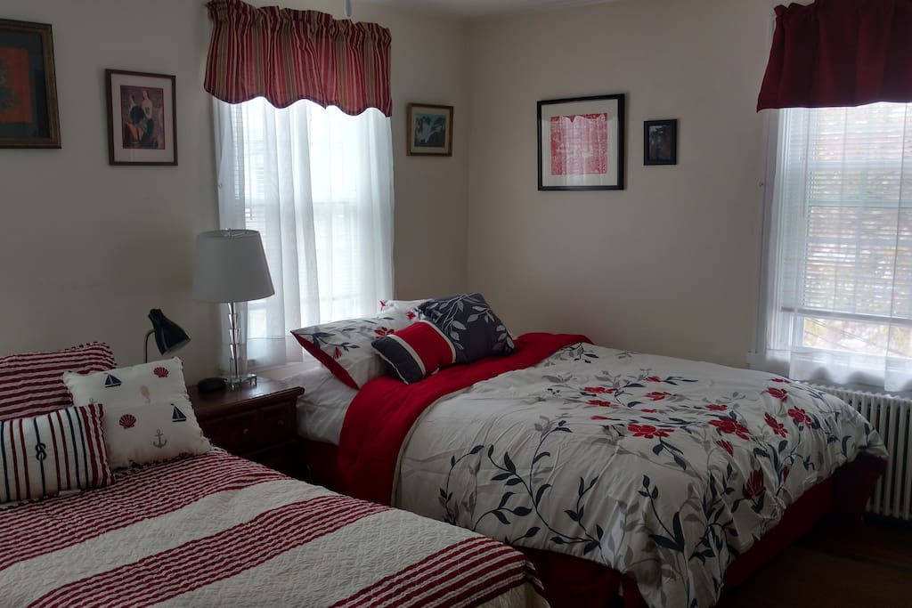 Spacious, light-filled guestroom with one queen bed and one twin