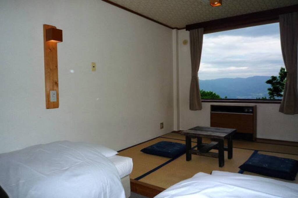 Room: This is the view of the room from the entrance. It has 2 single size beds and also 2 futons for your third and fourth guest. I can guarantee that you will enjoy it if you should decide to stay.