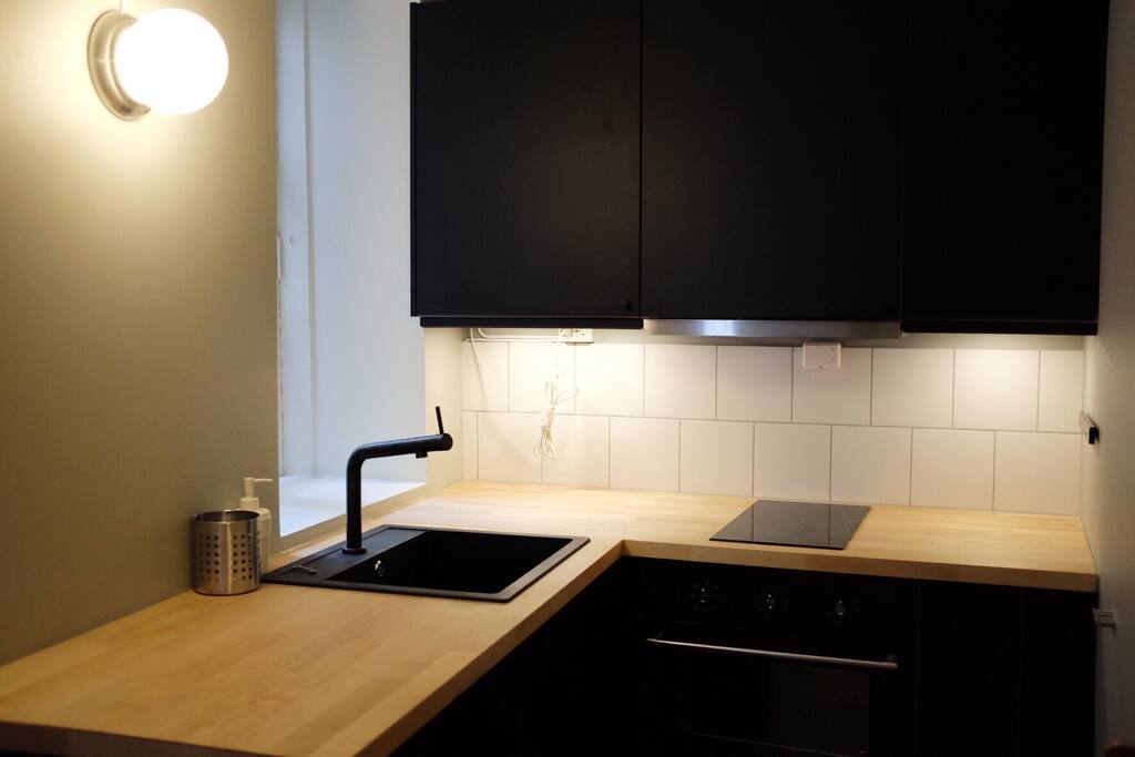 Kitchen with basic amenities, including washing machine.