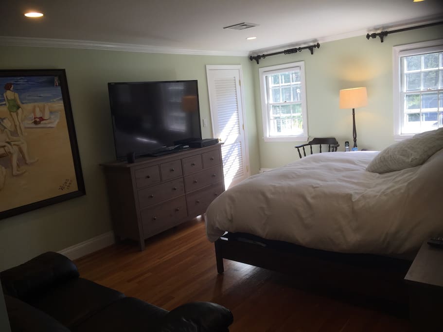 Master bedroom with king size bed, a walk-in closet and the master bathroom.