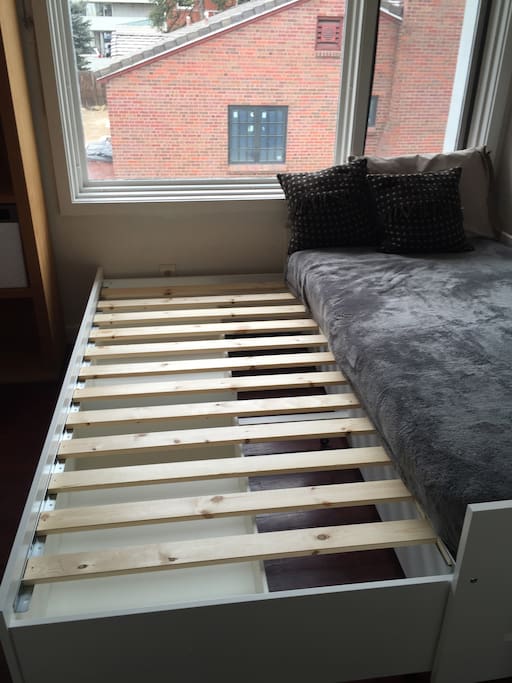 Bed pulls out to a double. Second mattress goes on top.