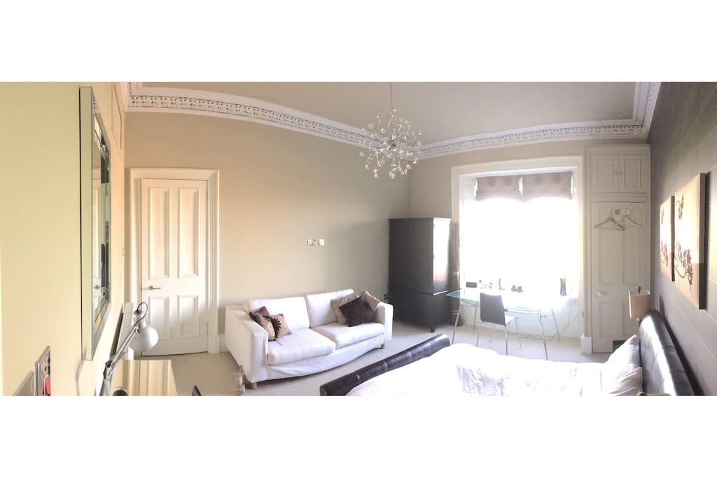Bedroom with ensuite bathroom and sofa
