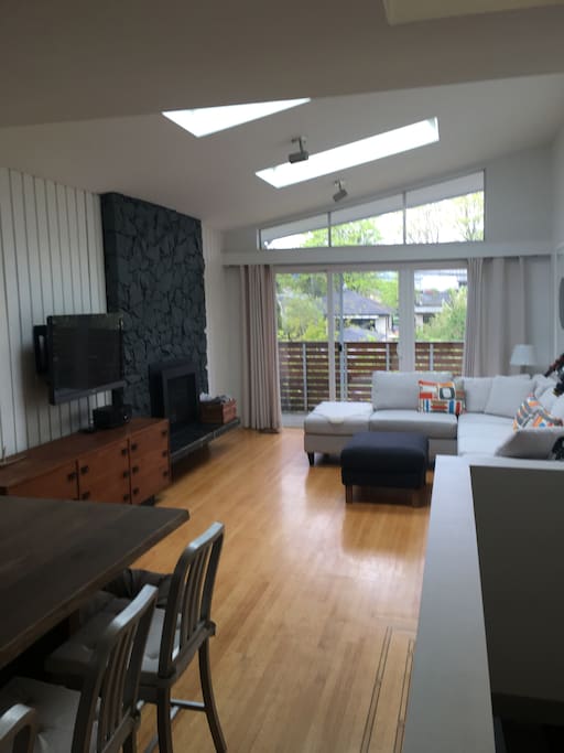 Living room features gas fireplace, TV and outdoor deck.