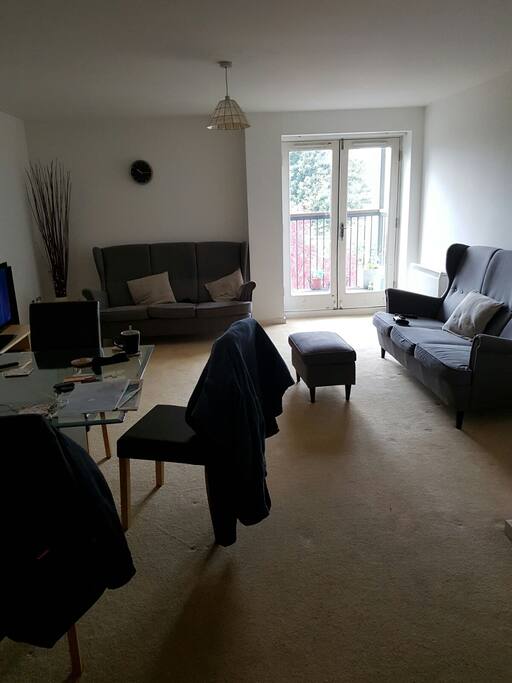 Lovely living room with dining table and balcony.