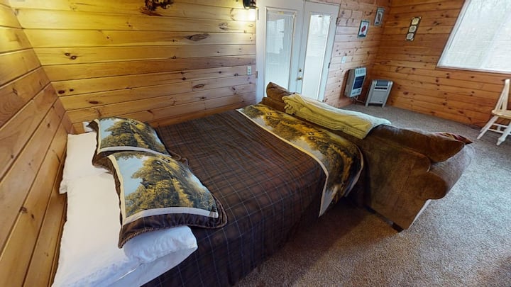 Queen sized  bed located to your left hand side when you enter the Cozy Cabin from the side porch. 