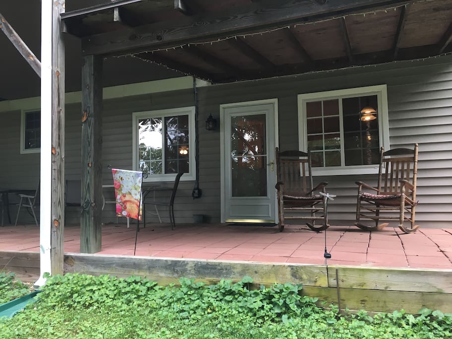 Patio and private entrance to apartment with rocking chairs to relax.