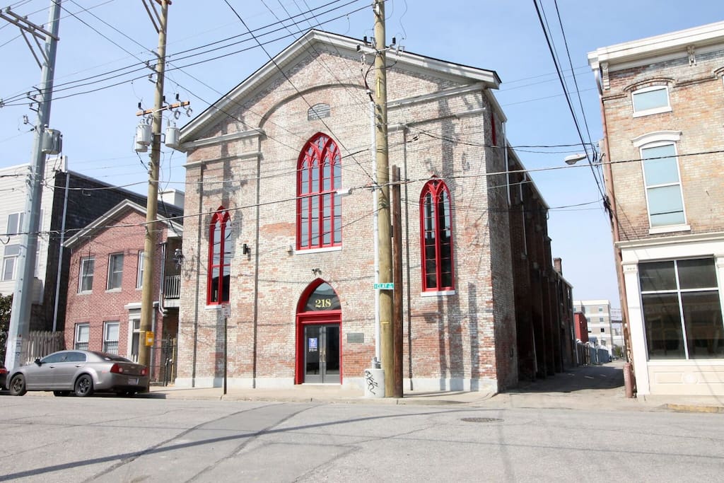 A view of the front facade of The Holy Goat. This building was designed and used as a church, until recently. It has been very well designed and repurposed as individual efficiency-style apartments.