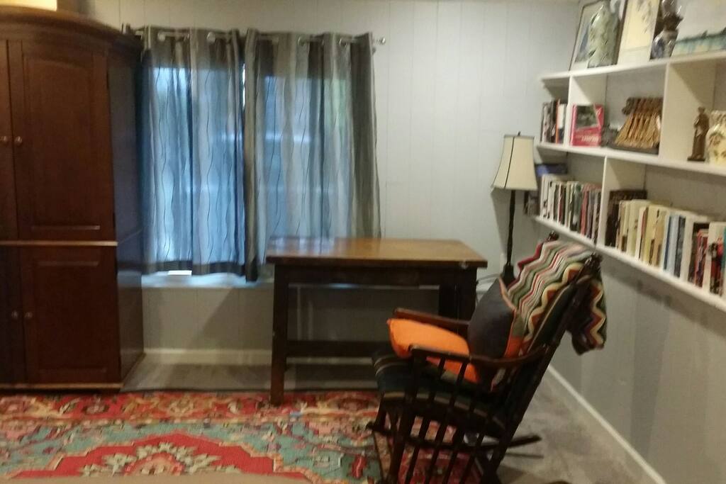 The west end of the bedroom has a desk and rocking chair. Also, plenty of books for bedtime reading.
