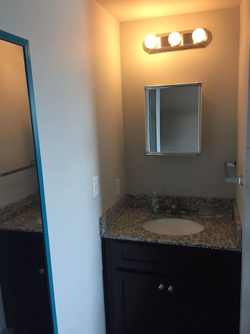 Sink and medicine cabinet with mirror outside the bathroom space for your convenience