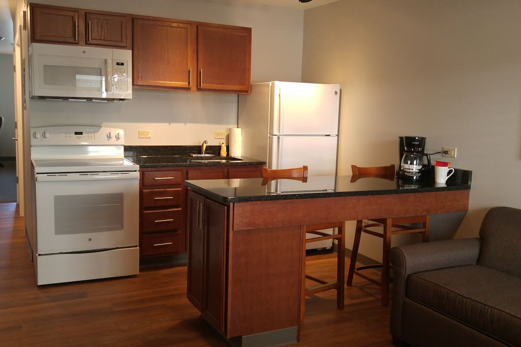Kitchen Area includes 4 burner stove with oven, Full size refrigerator with freezer, coffee maker, microwave
