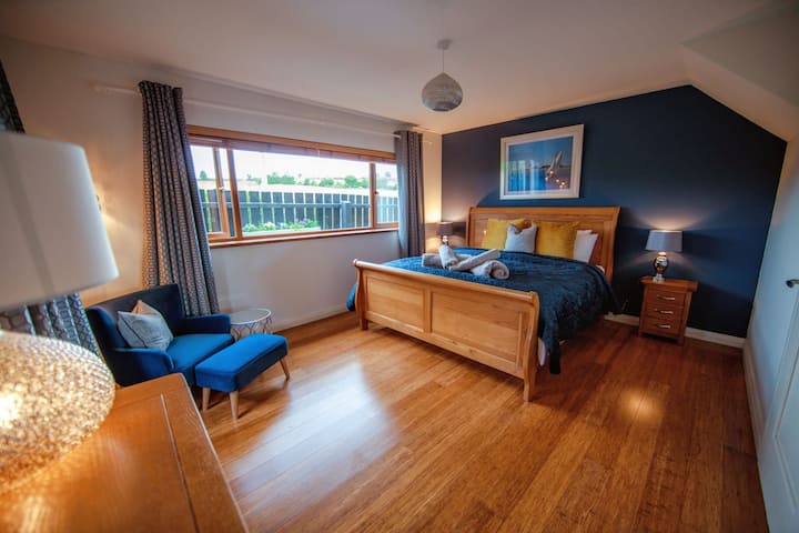 Luxury superking bed with premium mattress and bedding. Large bedroom with storage for clothing in chest of drawers and clothes rail. Full length mirror. Panoramic views of Slieve Donard and the Mourne Mountains from the bed. 
