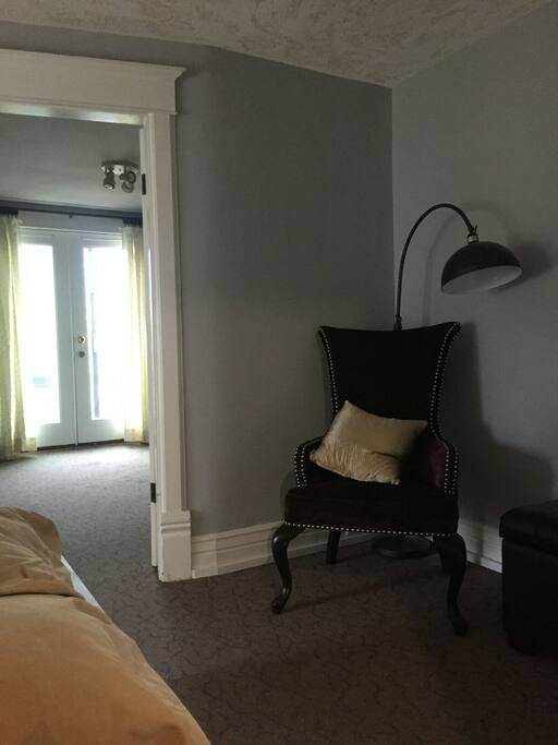 Unique seating area outside of bedroom and kitchen.