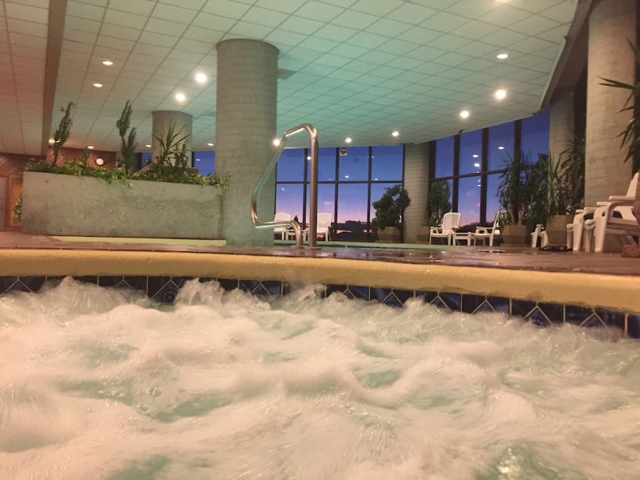 View of the indoor heated pool area from inside one of the large hot tubs. Ahhh... Life is Grand at the Top!
