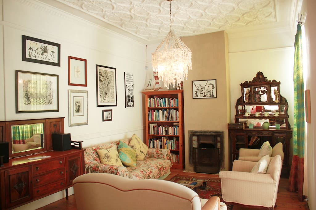 The living room comfortably seats eight. There are lots of great books and original art by local artists.
