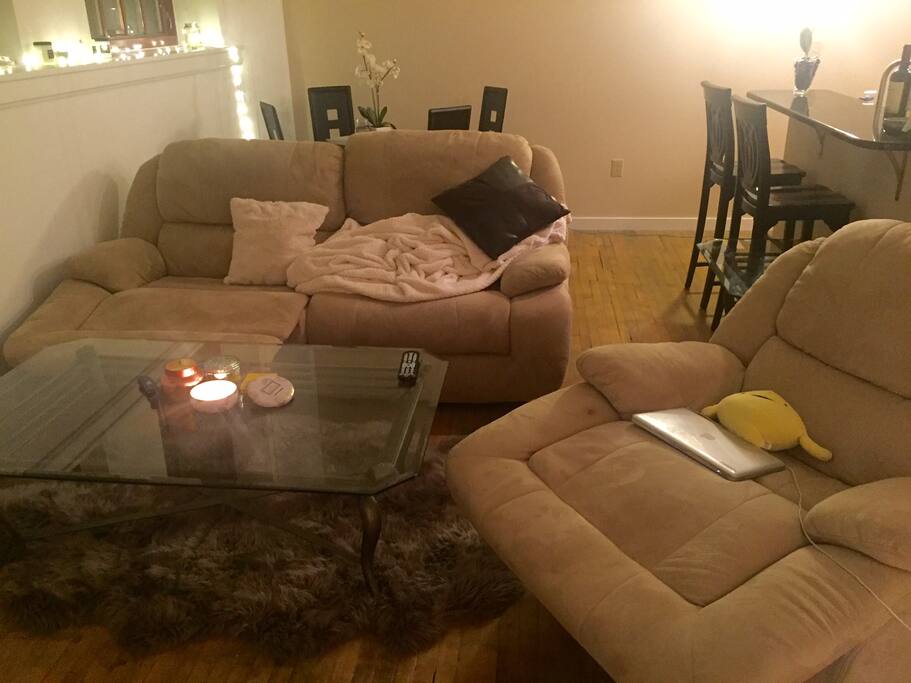 Genuine sheepskin rug in living room, comfortable couches