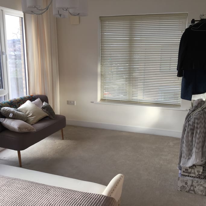 Extra space in bedroom with rail for clothes.