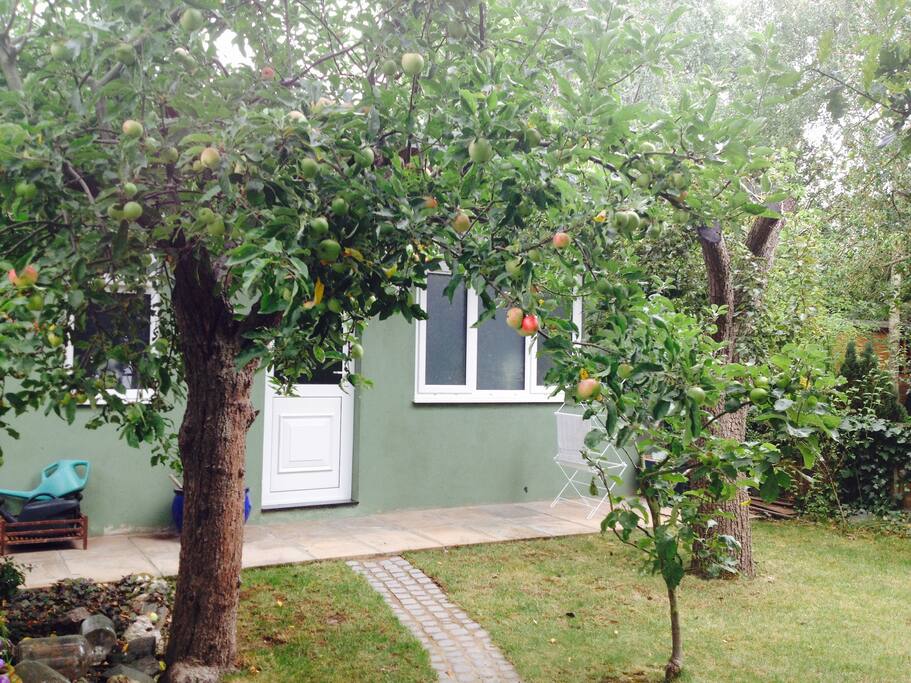 The apartment is surrounded by a large, well maintained garden.