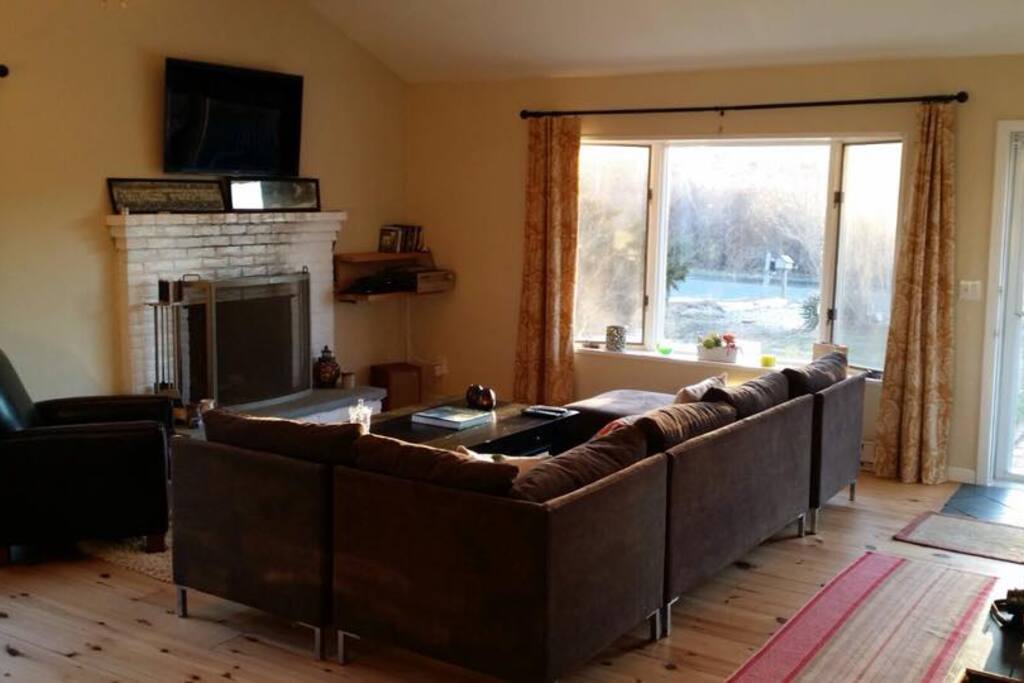 Living room with comfortable seating, indoor fireplace, HDtv with cable