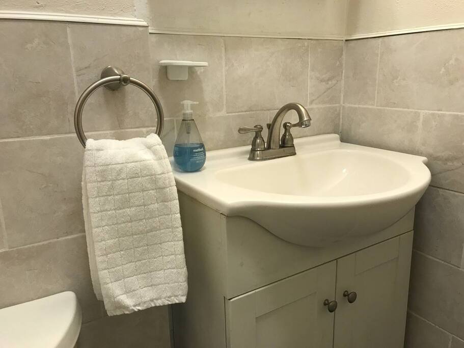 Small but functional bathroom with shower.