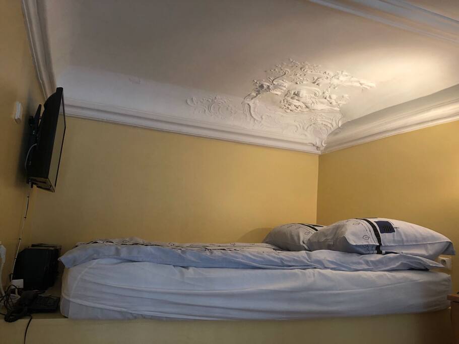 bedroom with a double bed and a tv station mounted to the wall