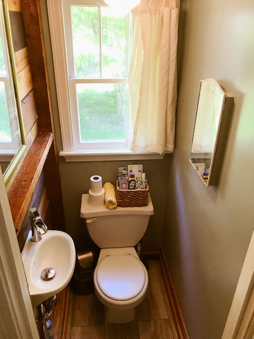 Bathroom and wash sink, lots of storage for a small space. Shelving and medicine cabinet. Also, forget something? We've got a nice basket of goodies.