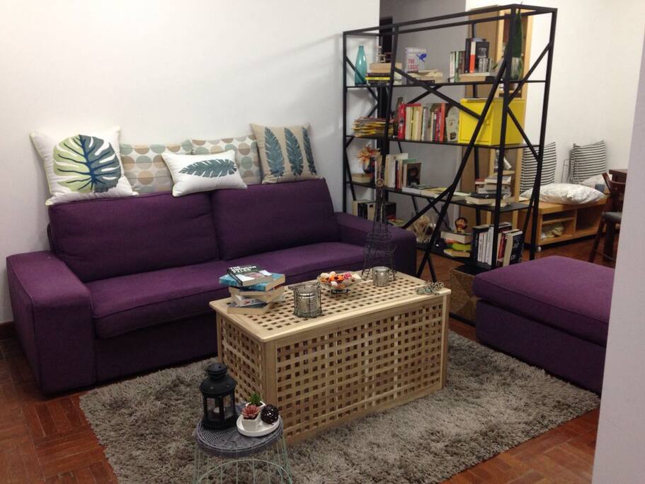 Living room w/super cozy couch n books to share.