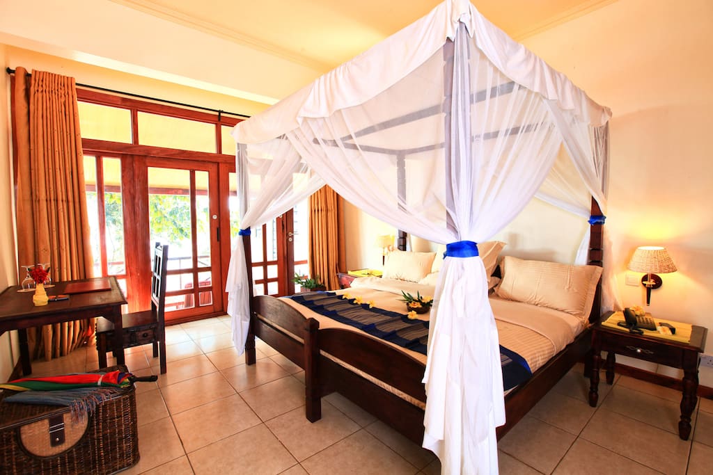 Four poster bed with mosquito nets