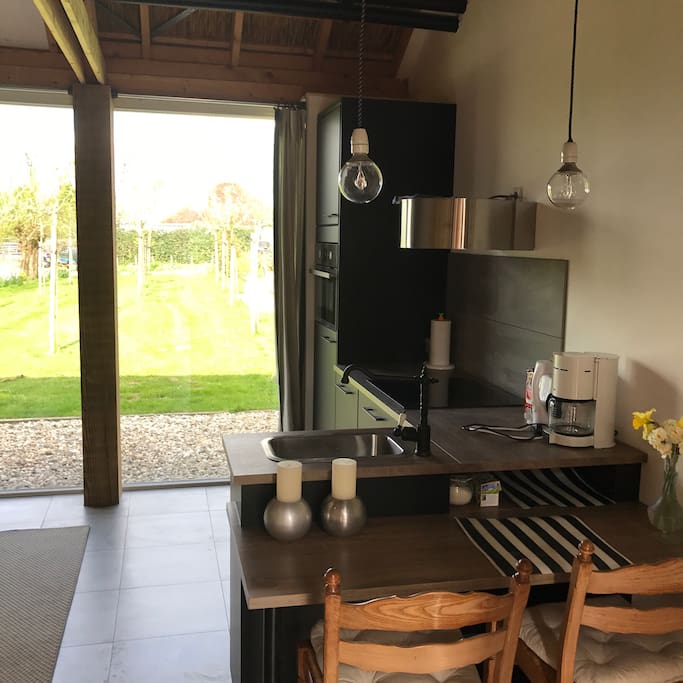 Modern kitchen with a beautiful view of the garden and surrounding countryside.
