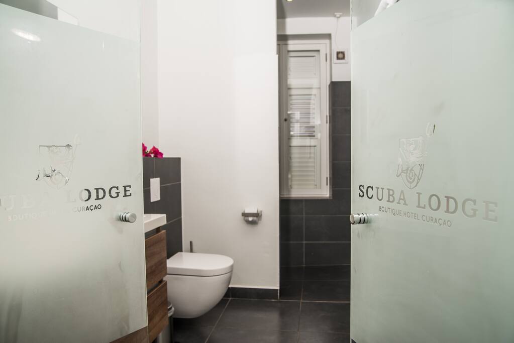 Modern and clean bathroom with rain shower. Daily cleaning is included.