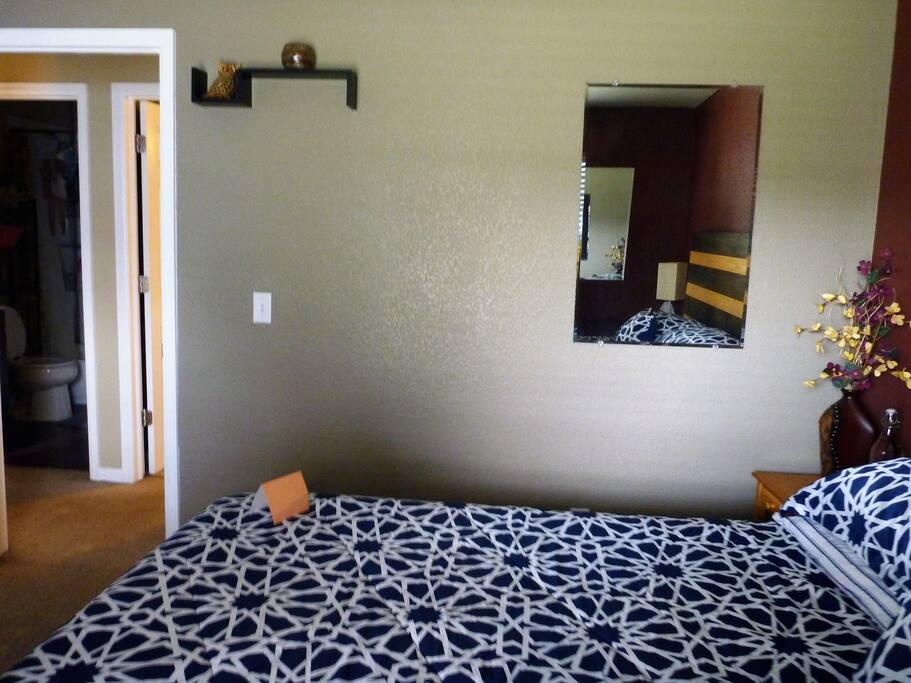 Bedroom #2 looking at entrance door and door to the bathroom just a step across the hall.